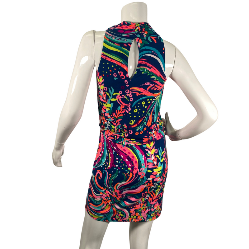 Load image into Gallery viewer,  Lilly Pultizer Psychedelic Neck Drop Cinched Waist Minidress is a vibrant, sleeveless dress with a colorful abstract pattern featuring shades of pink, green, yellow, and blue on a dark navy background - backside view
