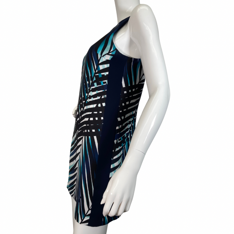 Load image into Gallery viewer, Trina Turk Shades of Blue Sleeveless Dress vibrant sleeveless shift dress showcases a striking tropical palm leaf pattern in shades of navy, teal, and white, evoking a fresh and breezy aesthetic side view
