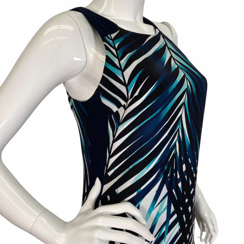 Load image into Gallery viewer, Trina Turk Shades of Blue Sleeveless Dress vibrant sleeveless shift dress showcases a striking tropical palm leaf pattern in shades of navy, teal, and white, evoking a fresh and breezy aesthetic side view close-up
