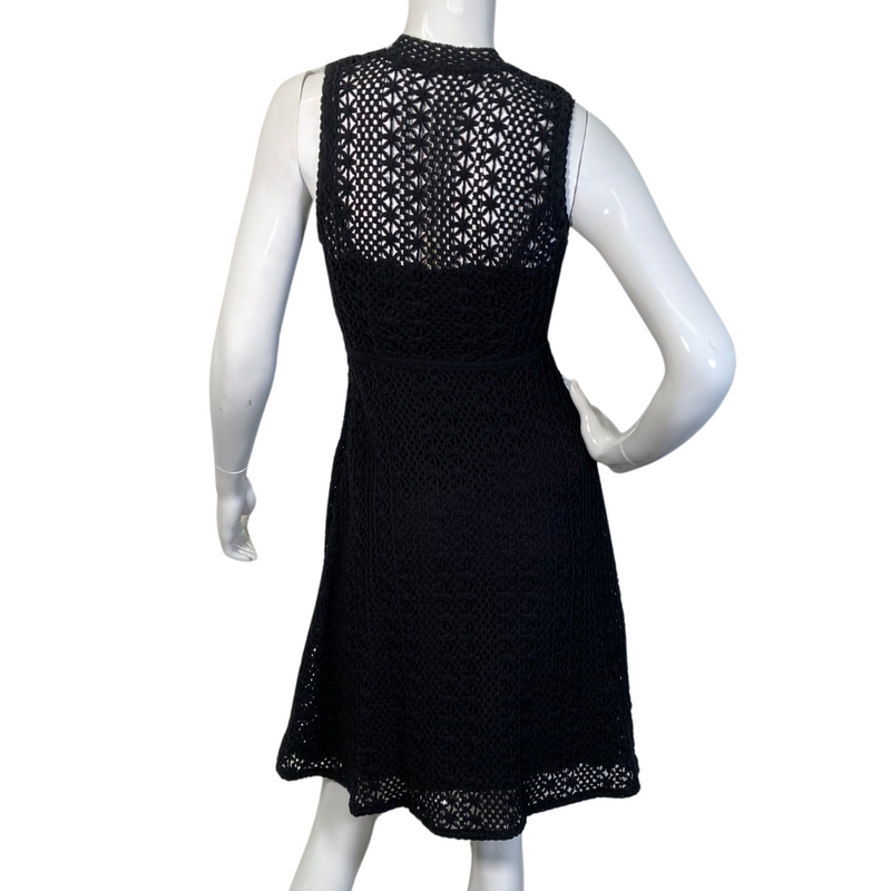 Load image into Gallery viewer, This Meadow Rue by Anthropologie Black Lace Knit Dress is a sleeveless, knee-length piece with a fitted silhouette - backside view.
