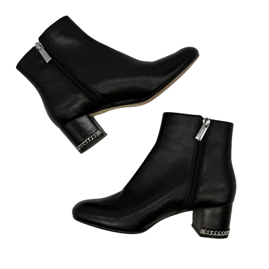 Michael Kors Black Leather Ankle Boots with Chain Detail, designed with a minimalist silhouette and edgy accents