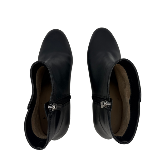 Pair of black ankle boots on a white background