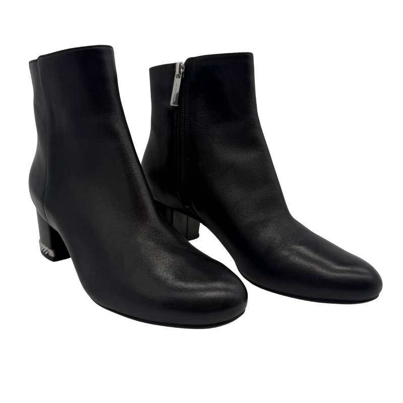 Load image into Gallery viewer, Pair of black leather ankle boots on a white background
