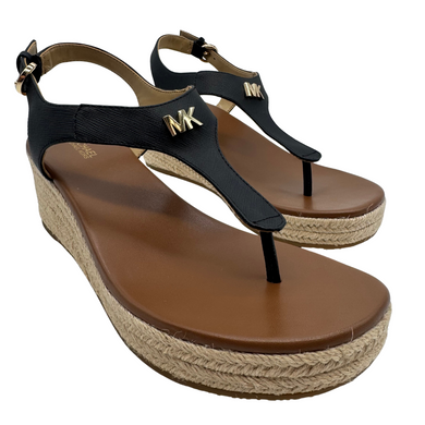 Michael Kors Laney Thong Faux Leather Sandals feature a sleek black T-strap design with gold-tone “MK” logo accents for a sophisticated touch