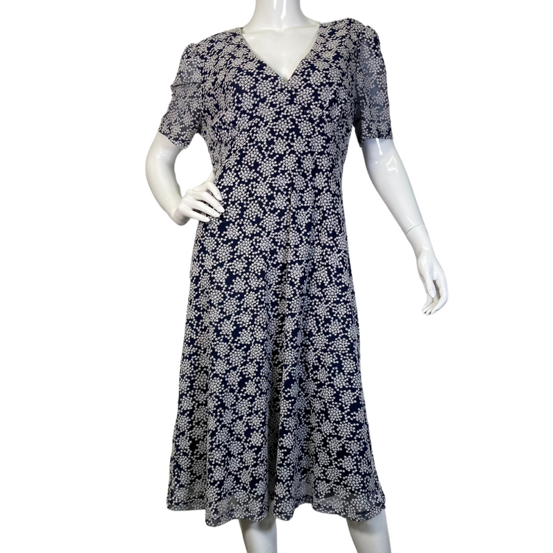 Load image into Gallery viewer, pre-loved Michael Kors Navy Blue Dress with Snowflake Pattern. It has short sleeves, a V-neckline, and a fitted bodice that flares into a slightly A-line skirt - front view
