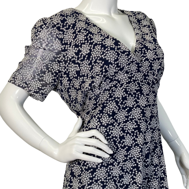 Load image into Gallery viewer, pre-loved Michael Kors Navy Blue Dress with Snowflake Pattern. It has short sleeves, a V-neckline, and a fitted bodice that flares into a slightly A-line skirt - side view close up
