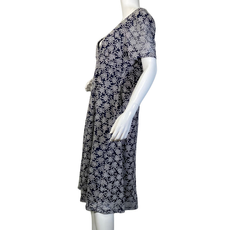 Load image into Gallery viewer, pre-loved Michael Kors Navy Blue Dress with Snowflake Pattern. It has short sleeves, a V-neckline, and a fitted bodice that flares into a slightly A-line skirt - side view
