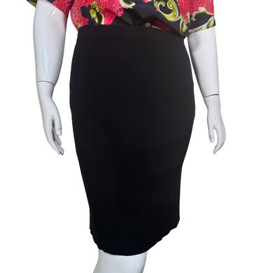 Black pencil skirt on a mannequin with a colorful top.