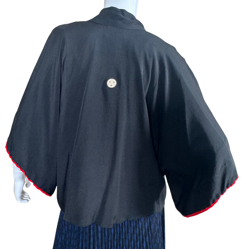 Load image into Gallery viewer, thrifted Montsuki Black Open-Front Kimono Cardigan with Red Trim. Designed with a relaxed silhouette and wide sleeves, this piece drapes beautifully for a flattering and effortless look

