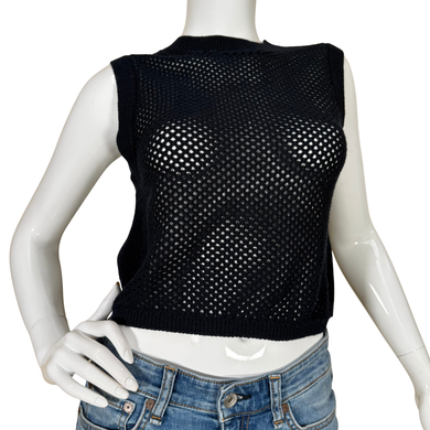 Black mesh vest on a mannequin with blue jeans against a white background