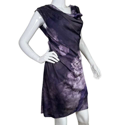 soft and artistic choice, this sleeveless Suzi Chin Elegant Draped Purple Dress showcases a watercolor-inspired floral print in shades of purple and lavender on a deep background.