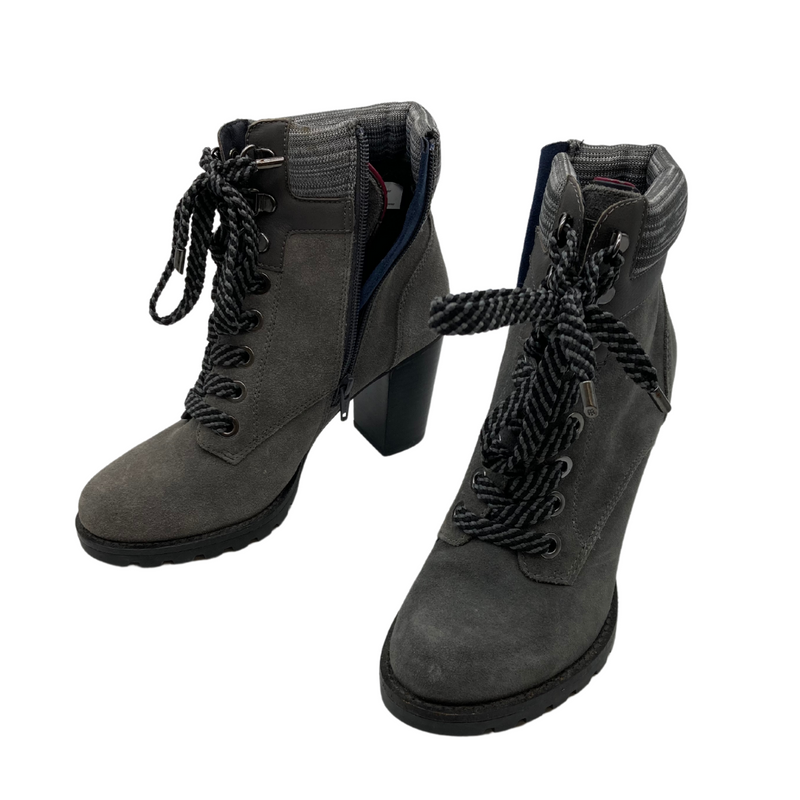 Load image into Gallery viewer, Tommy Hilfiger Grey Heel Boots are trendy heeled ankle boots with a rugged yet stylish design. They feature a lace-up front with bold, thick laces for an edgy look, complemented by a side zipper for easy wear.
