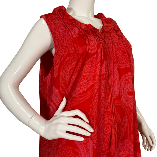 Red patterned dress on a mannequin against a white background