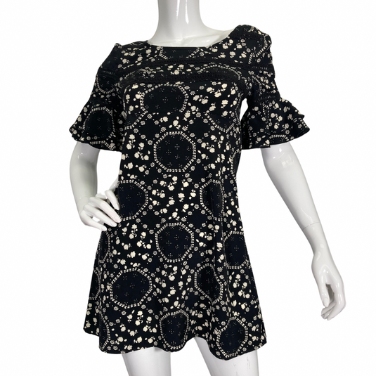 Free People Floral Black and White Dress features an intricate white floral and geometric print, creating a playful yet elegant pattern - front view