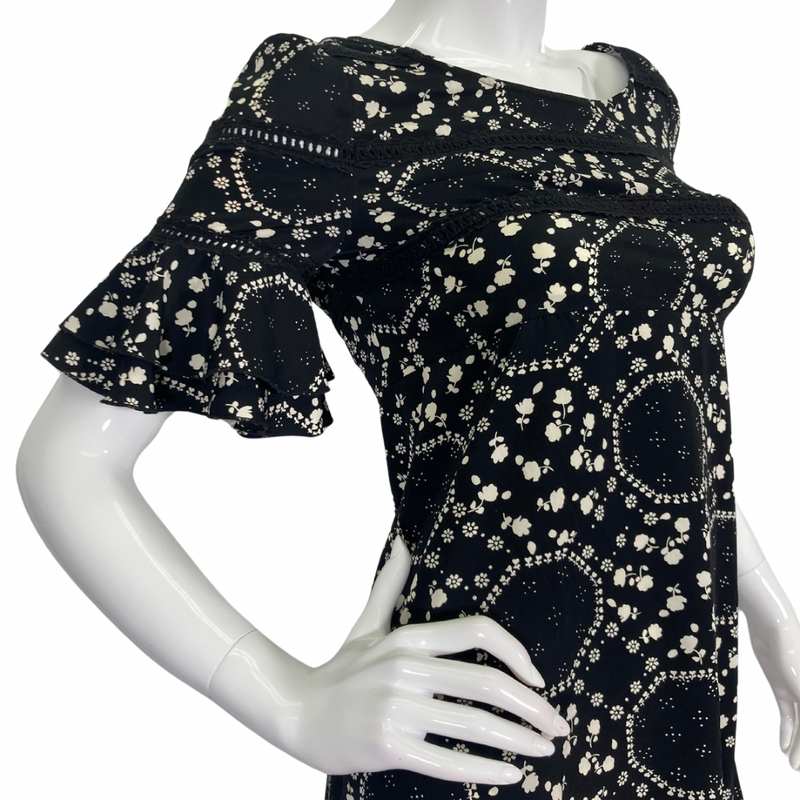 Load image into Gallery viewer, Free People Floral Black and White Dress features an intricate white floral and geometric print, creating a playful yet elegant pattern side view - close-up
