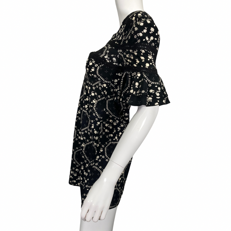 Load image into Gallery viewer, Free People Floral Black and White Dress features an intricate white floral and geometric print, creating a playful yet elegant pattern side view side view
