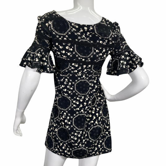 Free People Floral Black and White Dress features an intricate white floral and geometric print, creating a playful yet elegant pattern side view backside view