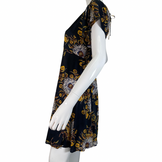 Madewell Black Dress with Bold Floral Pattern features a delicate pattern with white, yellow, and brown tones set against a black background, creating a striking and sophisticated look side view