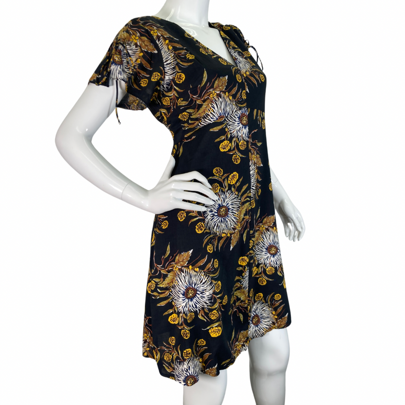 Load image into Gallery viewer, Madewell Black Dress with Bold Floral Pattern features a delicate pattern with white, yellow, and brown tones set against a black background, creating a striking and sophisticated look side look
