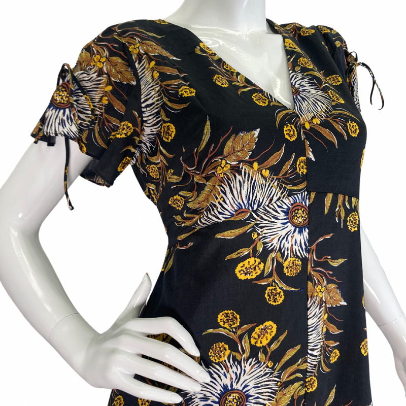 Load image into Gallery viewer, Madewell Black Dress with Bold Floral Pattern features a delicate pattern with white, yellow, and brown tones set against a black background, creating a striking and sophisticated look side look close-up
