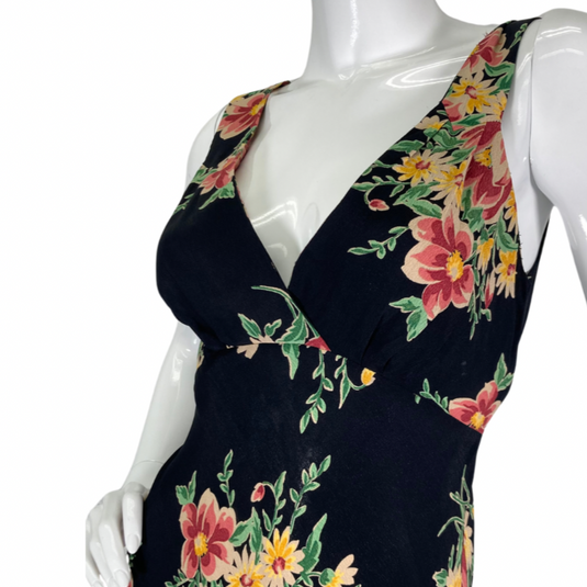 Betsey Johnson Floral sleeveless, V-neck black dress with colorful floral print and wide straps, close up view of V-neck