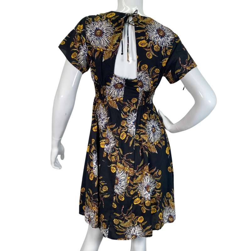 Load image into Gallery viewer, Madewell Black Dress with Bold Floral Pattern features a delicate pattern with white, yellow, and brown tones set against a black background, creating a striking and sophisticated look backside view
