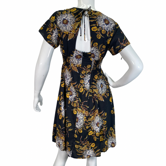 Madewell Black Dress with Bold Floral Pattern features a delicate pattern with white, yellow, and brown tones set against a black background, creating a striking and sophisticated look backside view