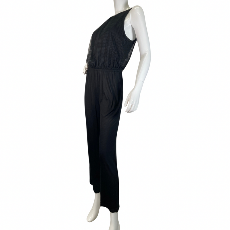 Load image into Gallery viewer, Trina Turk Black Sleek and Stylish Jumpsuit featuring a textured mesh overlay on the bodice for added dimension and elegance - side view 
