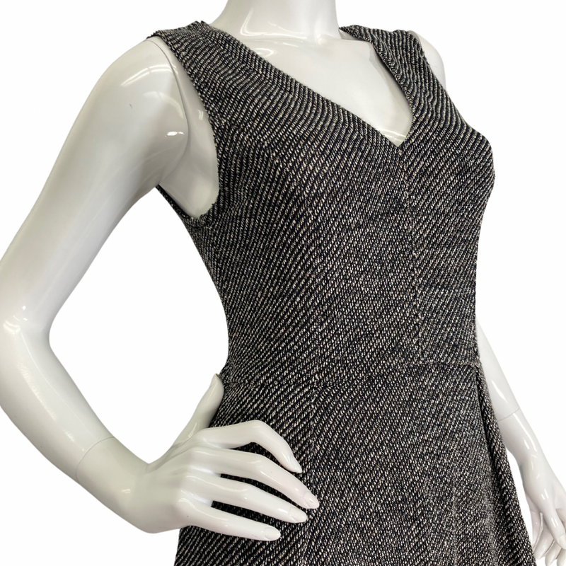 Load image into Gallery viewer, Madewell Grey Knitted Sleeveless Dress features a flattering V-neckline and a textured black-and-white herringbone pattern, creating a timeless and sophisticated look side view - close up
