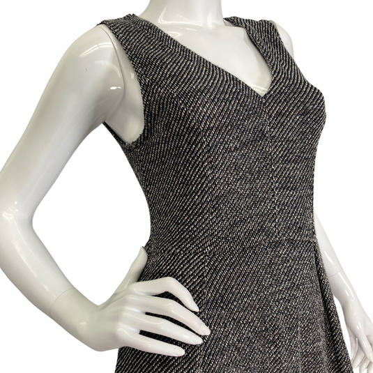 Madewell Grey Knitted Sleeveless Dress features a flattering V-neckline and a textured black-and-white herringbone pattern, creating a timeless and sophisticated look side view - close up