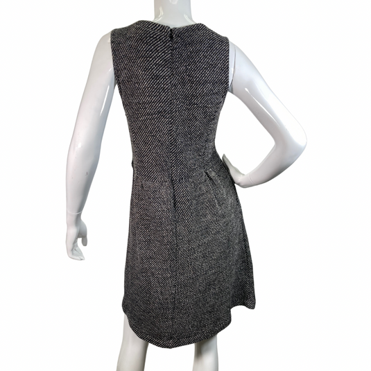 Madewell Grey Knitted Sleeveless Dress features a flattering V-neckline and a textured black-and-white herringbone pattern, creating a timeless and sophisticated look backside view