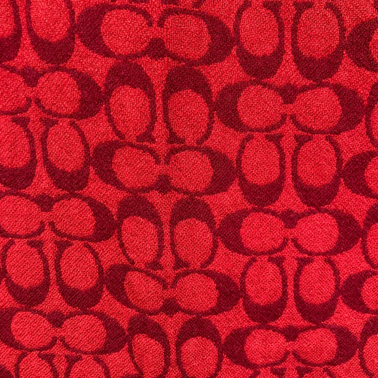 Coach Black and Red Monogram Scarf close up of the chic and intricate pattern of interlocking Coach monogram