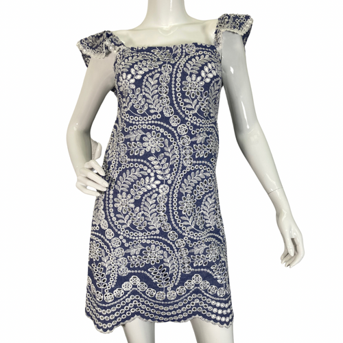 Alice + Olivia Blue Dress with Embroidered White Lace Design is a delicate and elegant piece featuring a blue base adorned with intricate white lace embroidery in floral and paisley patterns front view