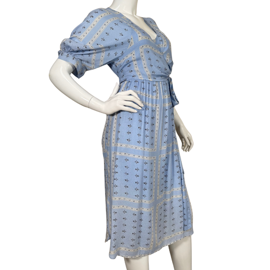 Mannequin wearing a blue dress with a pattern on a white background