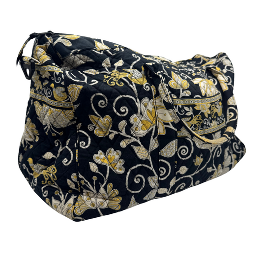 Vera Bradley Black Duffle Bag with Golden and White Design is a quilted fabric bag with a black background and an intricate floral pattern in gold, white, and beige