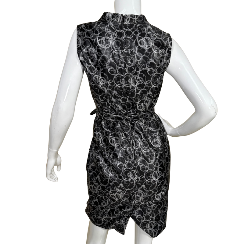 Load image into Gallery viewer, Black sleeveless dress with white circular pattern on a mannequin against a white background
