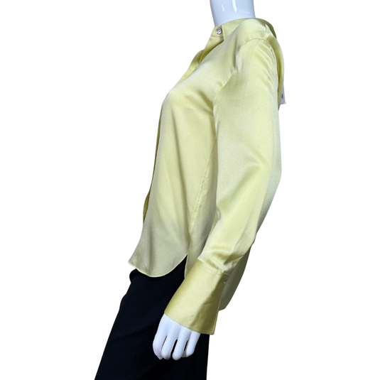Light green blouse on a mannequin against a white background