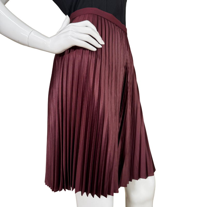 Load image into Gallery viewer, Maroon pleated skirt on a mannequin against a white background
