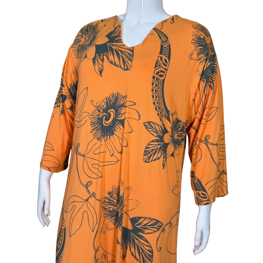 Orange dress with black floral patterns on a mannequin against a white background