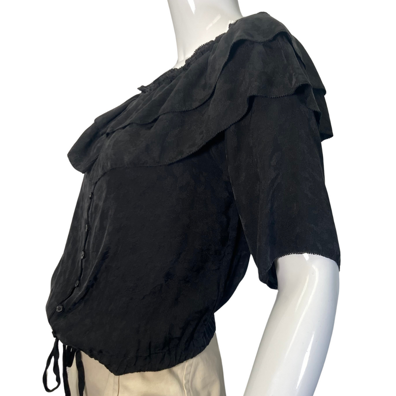 Load image into Gallery viewer, This pre-loved Zadig &amp; Voltaire Black Ruffle Blouse is a vintage-inspired short-sleeve blouse with layered ruffle details along the neckline, button-down front, and an adjustable drawstring waist for a flattering fit - side view
