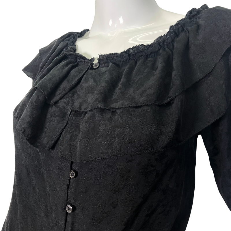 Load image into Gallery viewer, This pre-loved Zadig &amp; Voltaire Black Ruffle Blouse is a vintage-inspired short-sleeve blouse with layered ruffle details along the neckline, button-down front, and an adjustable drawstring waist for a flattering fit - close up view
