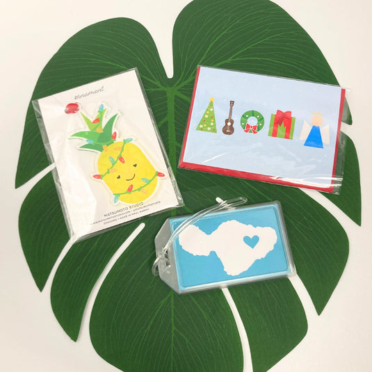 Aloha Christmas Pineapple Set by Matsumoto Studio on leaf including pineapple ornament, greeting card, and maui luggage tag